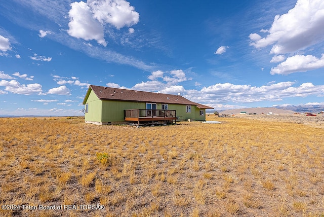 rear view of house featuring a deck with mountain view