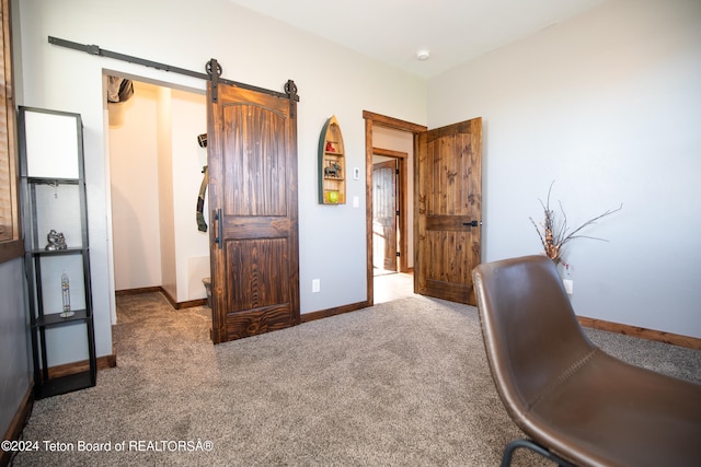 home office with a barn door and carpet