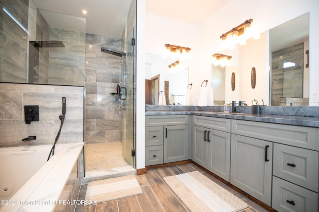 bathroom featuring wood-type flooring, vanity, and separate shower and tub