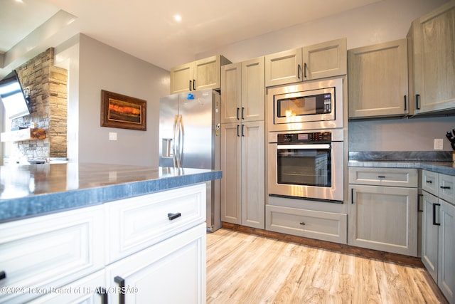 kitchen featuring gray cabinets, appliances with stainless steel finishes, and light hardwood / wood-style floors