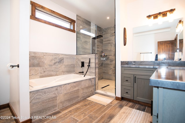 bathroom with independent shower and bath and vanity