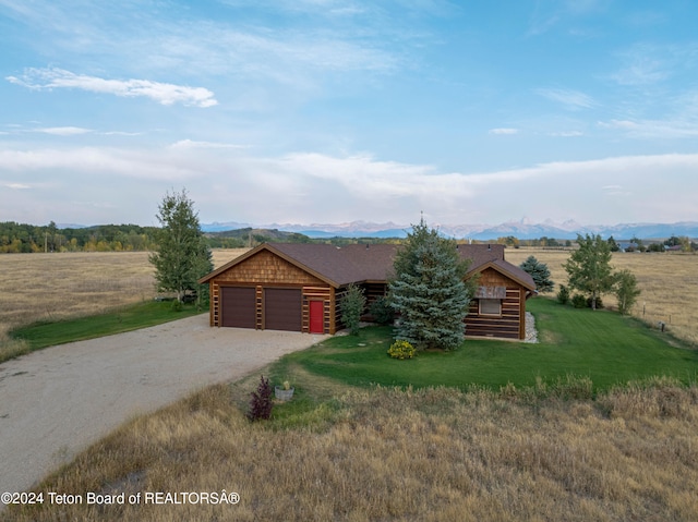 4120 W 9500 N, Tetonia, ID 83452 - log-style house with a rural view, a front yard, a garage, and a mountain view