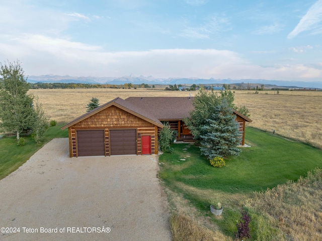 4120 W 9500 N, Tetonia, ID 83452 - log-style house with a mountain view, a front yard, a rural view, and a garage