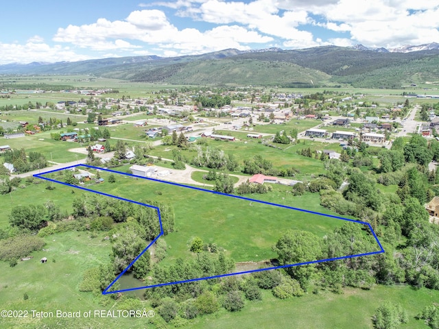 birds eye view of property with a mountain view