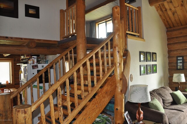 stairs with wooden ceiling and lofted ceiling with beams