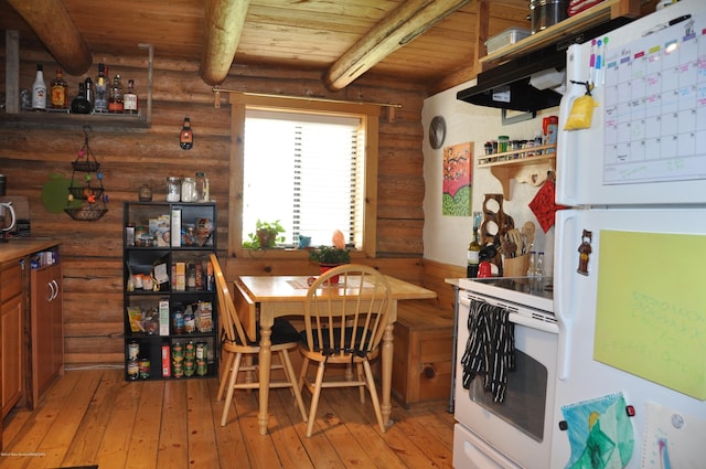 dining space with light hardwood / wood-style floors, rustic walls, beam ceiling, and wooden ceiling