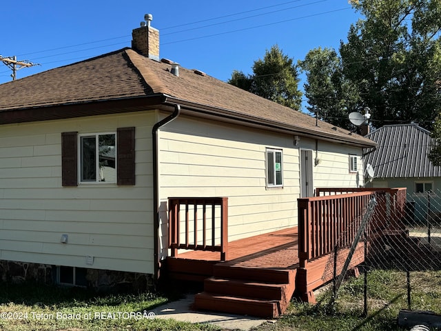 back of house with a wooden deck