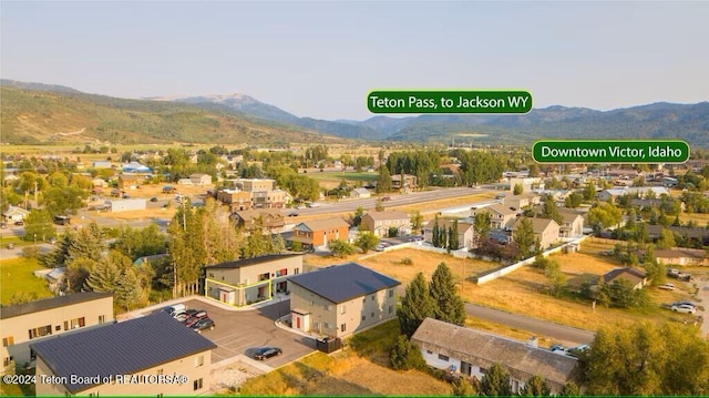 birds eye view of property with a mountain view