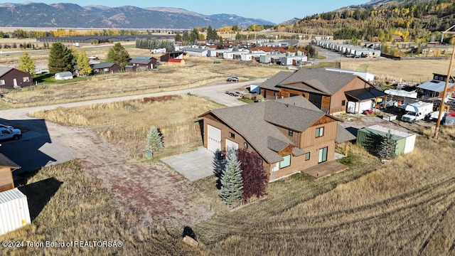 birds eye view of property with a mountain view