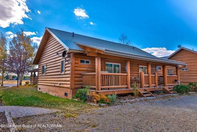 log cabin with covered porch