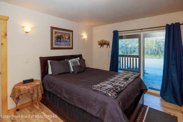 bedroom with access to outside and light wood-type flooring