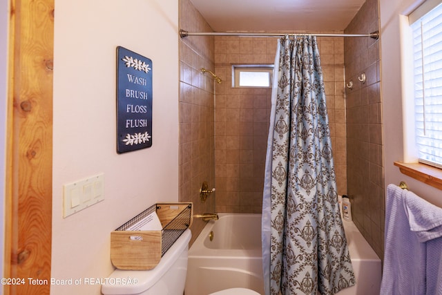 bathroom featuring shower / bath combination with curtain and toilet