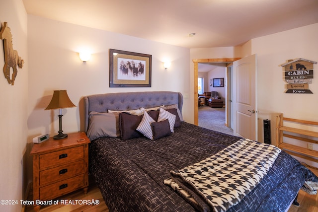 bedroom with hardwood / wood-style floors