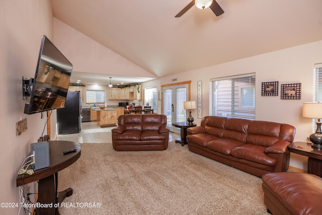 living room featuring ceiling fan, plenty of natural light, and light carpet