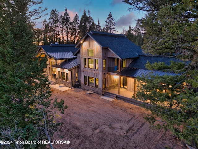 view of back house at dusk