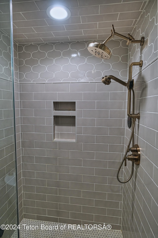 bathroom with a tile shower