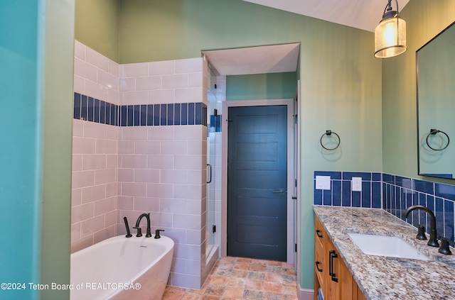 bathroom with tile walls, vanity, and plus walk in shower