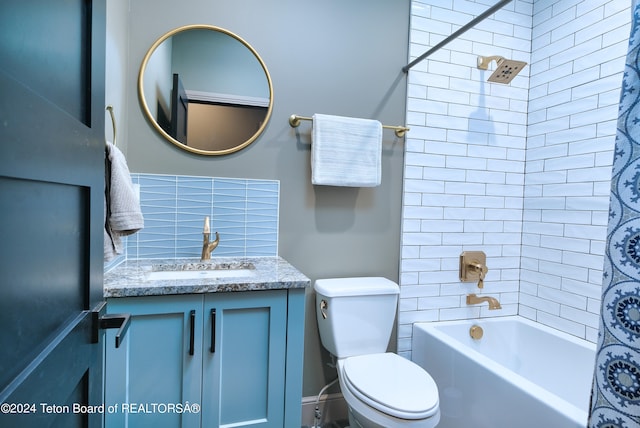 full bathroom featuring vanity, shower / bath combo with shower curtain, and toilet