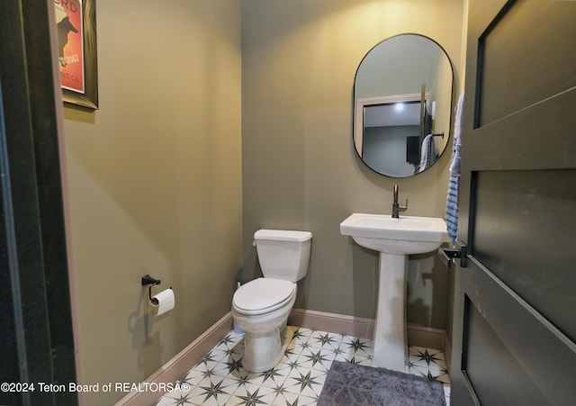 bathroom with tile patterned floors and toilet