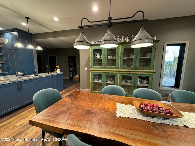 dining room featuring light hardwood / wood-style flooring and sink