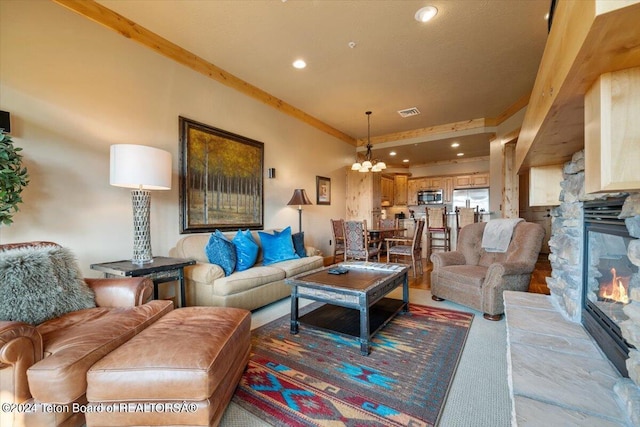 living area with an inviting chandelier, visible vents, a fireplace, and recessed lighting
