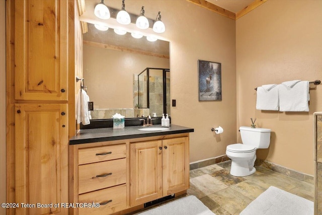 full bathroom with toilet, baseboards, stone finish flooring, a shower stall, and vanity