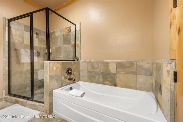 full bath with a bath and a stall shower
