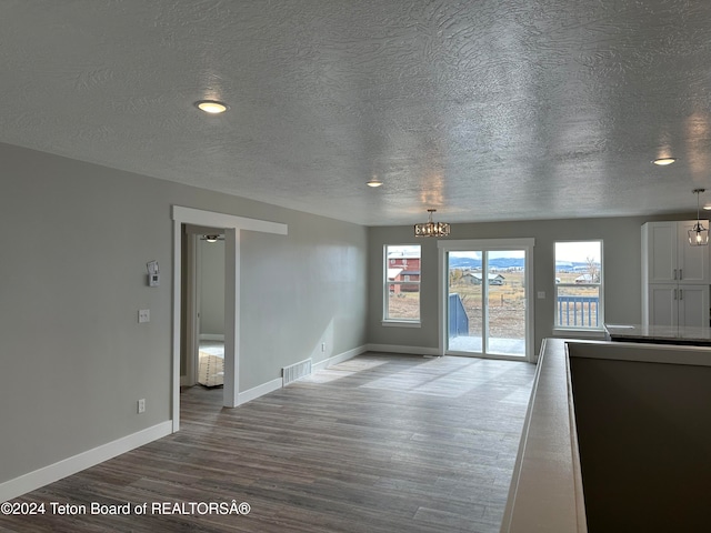 unfurnished room featuring hardwood / wood-style flooring and a chandelier