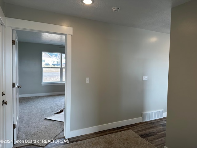 corridor with a textured ceiling