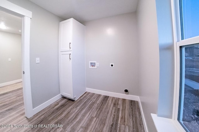 laundry area with cabinets, washer hookup, light hardwood / wood-style flooring, and electric dryer hookup