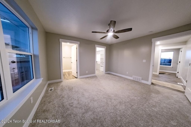 interior space with ceiling fan