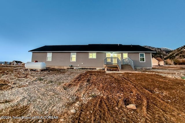 back of property with a mountain view