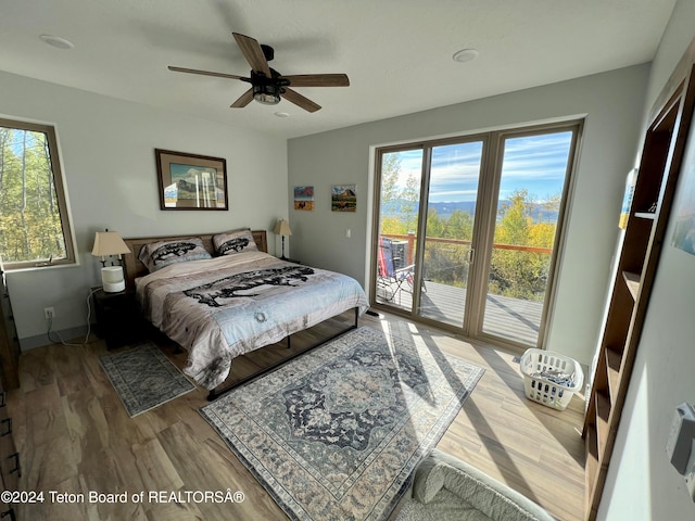 bedroom with ceiling fan, hardwood / wood-style floors, and access to exterior