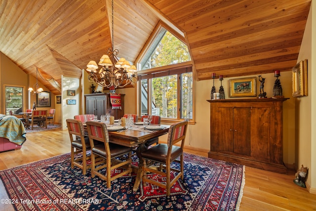 dining space with light hardwood / wood-style floors, wood ceiling, vaulted ceiling, and an inviting chandelier