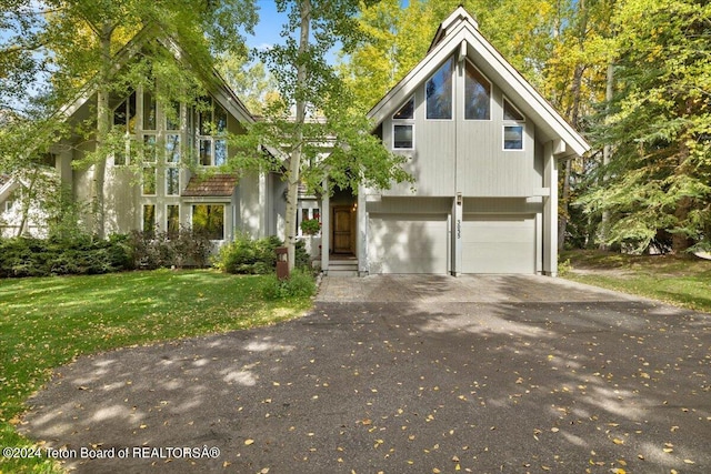 view of front of property with a garage and a front yard