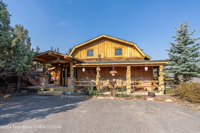 log cabin with a porch