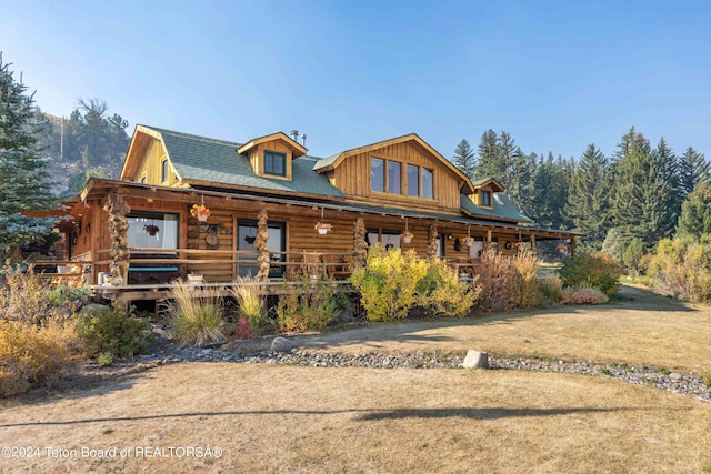 log cabin with covered porch