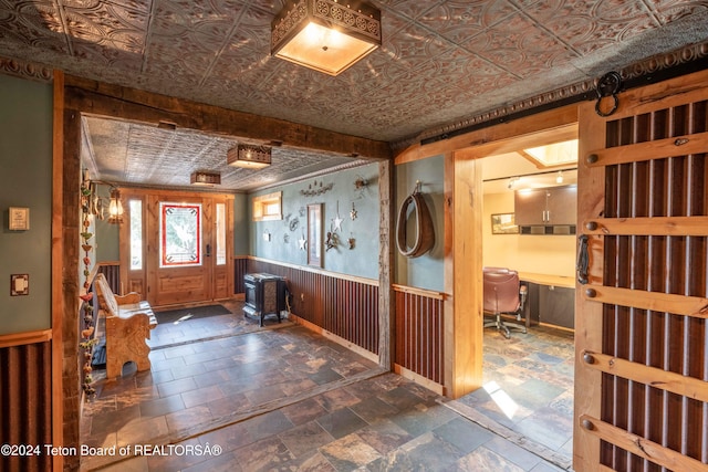 foyer featuring wooden walls