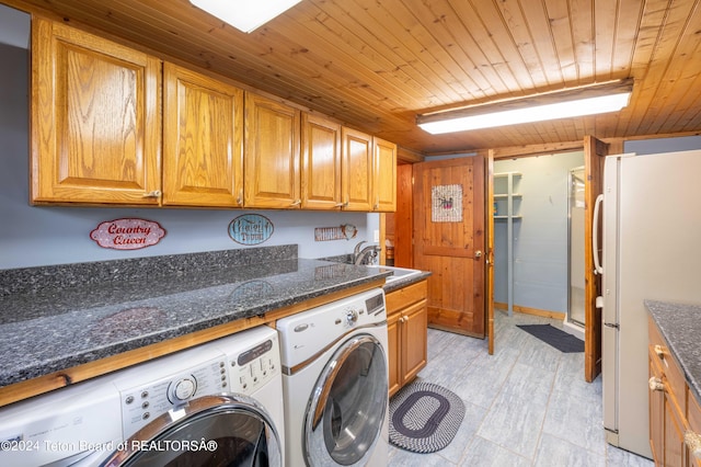 laundry area featuring separate washer and dryer, cabinets, sink, and wooden ceiling