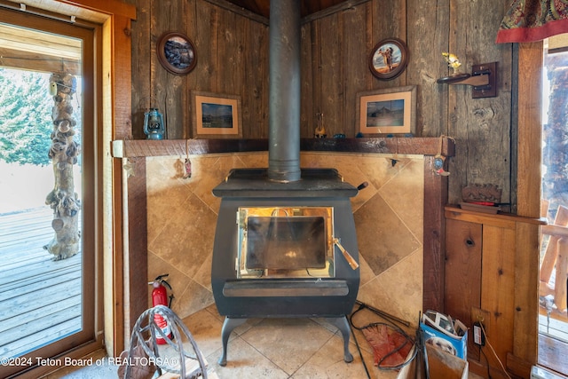 interior details featuring wooden walls and a wood stove