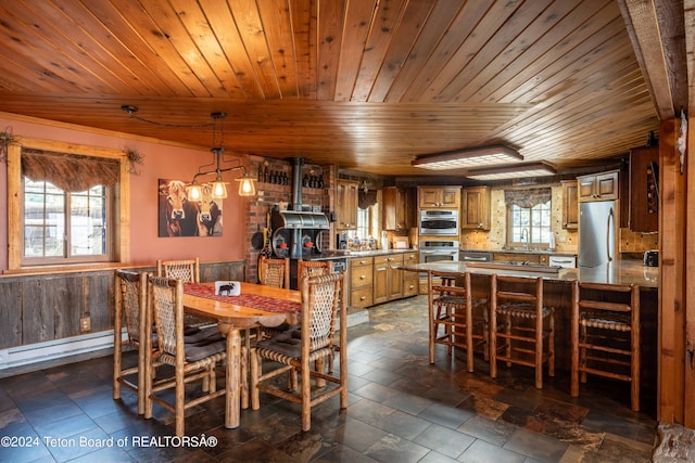 dining space with a healthy amount of sunlight and wooden ceiling