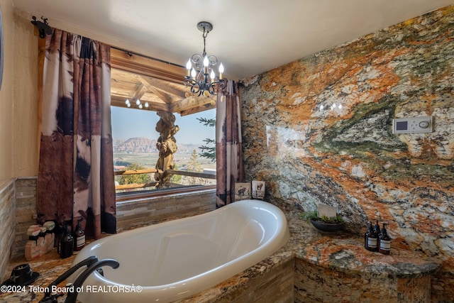 bathroom with a relaxing tiled tub and a chandelier