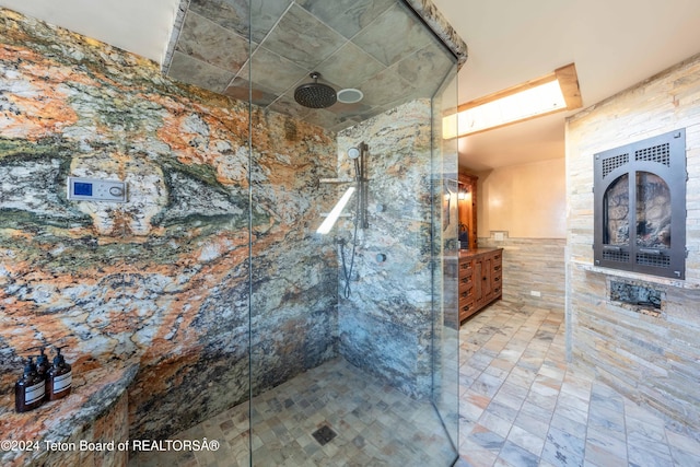 bathroom with vanity, tile walls, and a tile shower