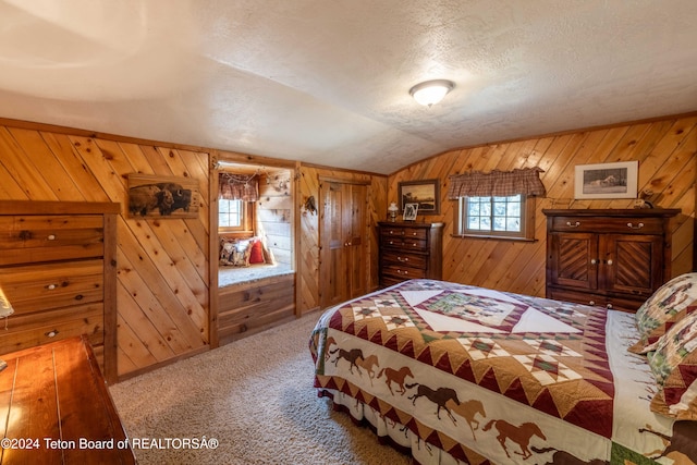 carpeted bedroom featuring wood walls, vaulted ceiling, and a textured ceiling