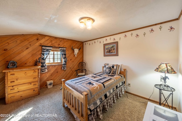 carpeted bedroom featuring lofted ceiling, ornamental molding, wooden walls, and a textured ceiling