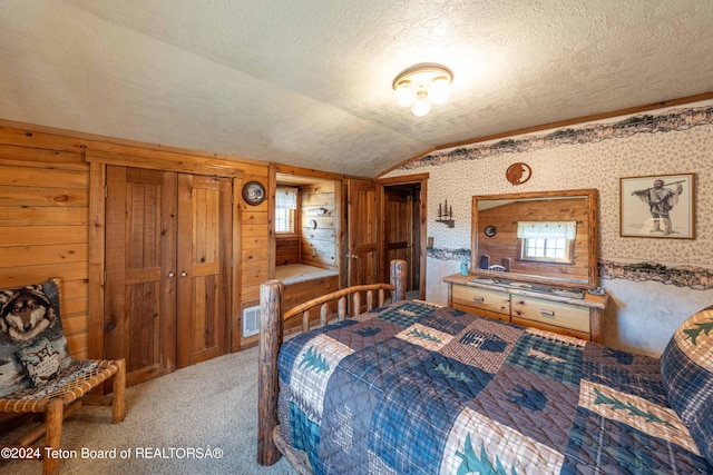 65 Bald Mountain Rd, Dubois, WY 82513 - bedroom featuring vaulted ceiling, carpet, a textured ceiling, wallpapered walls, and multiple windows