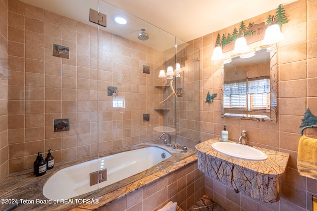 65 Bald Mountain Rd, Dubois, WY 82513 - full bathroom with tile walls, a sink, a combined bath / shower with rainfall shower, and recessed lighting