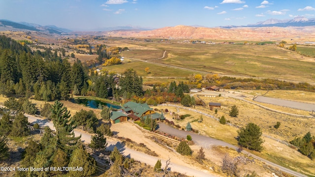 birds eye view of property with a rural view and a mountain view