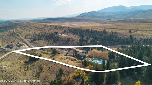 aerial view featuring a water and mountain view