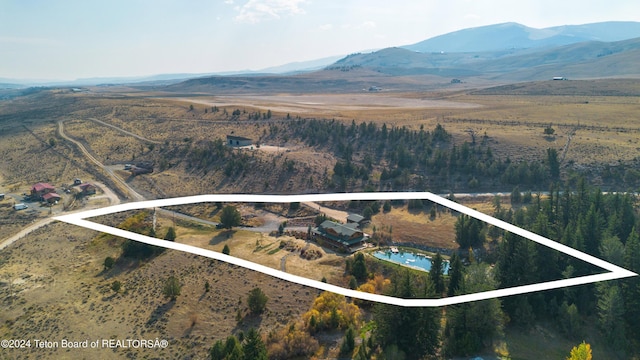 65 Bald Mountain Rd, Dubois, WY 82513 - view of property location featuring a mountainous background, property boundaries highlighted, and rural landscape
